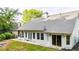 Home exterior with a patio, multiple windows, sliding doors, and a well-maintained lawn at 507 Huntgate Rd, Woodstock, GA 30189