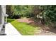 View of the side yard with tiered landscaping with steps and lawn at 507 Huntgate Rd, Woodstock, GA 30189
