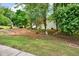 Expansive backyard features lush greenery, mature trees, and plenty of space for outdoor activities at 507 Huntgate Rd, Woodstock, GA 30189