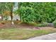 Expansive backyard features lush greenery, mature trees, and plenty of space for outdoor activities at 507 Huntgate Rd, Woodstock, GA 30189