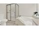 Bathroom featuring a shower, bathtub, and toilet with a window nearby at 507 Huntgate Rd, Woodstock, GA 30189