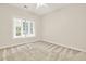 This bright bedroom features a ceiling fan and large window with outdoor view at 507 Huntgate Rd, Woodstock, GA 30189