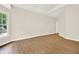 Bedroom with hardwood floors, tray ceilings, and a window at 507 Huntgate Rd, Woodstock, GA 30189