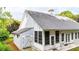 Exterior home view showing an enclosed sunroom with ample windows and a gray shingled roof at 507 Huntgate Rd, Woodstock, GA 30189