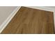 Close up of dark, laminate flooring with white trim at 507 Huntgate Rd, Woodstock, GA 30189