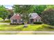 Charming brick home featuring a well-manicured lawn and established trees at 507 Huntgate Rd, Woodstock, GA 30189