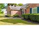 Charming brick home with lush landscaping, green lawn, and mature hedges at 507 Huntgate Rd, Woodstock, GA 30189
