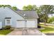 Two-car garage with white doors and well-maintained landscaping around the perimeter at 507 Huntgate Rd, Woodstock, GA 30189