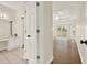 Hallway leading to main bedroom and featuring multiple access doors at 507 Huntgate Rd, Woodstock, GA 30189