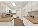 Bright kitchen with white cabinets and butcher block countertops at 507 Huntgate Rd, Woodstock, GA 30189