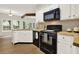 Kitchen with white cabinets and black appliances at 507 Huntgate Rd, Woodstock, GA 30189