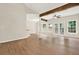 Spacious living room with wood floors, exposed beams, and natural light at 507 Huntgate Rd, Woodstock, GA 30189