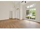 Open living room with large windows, wood floors, and lots of natural light at 507 Huntgate Rd, Woodstock, GA 30189