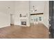 Inviting living room with high ceilings, fireplace, and wood floors at 507 Huntgate Rd, Woodstock, GA 30189