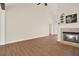 Open living room with fireplace, wood floors, vaulted ceilings, and neutral paint at 507 Huntgate Rd, Woodstock, GA 30189