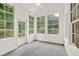 Sunroom features many windows, white trim, and access to the outdoors at 507 Huntgate Rd, Woodstock, GA 30189