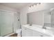 Bathroom featuring a double vanity sink, updated mirror, and a shower with sliding glass doors at 846 Brandy Oaks Ln, Stone Mountain, GA 30088
