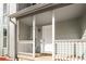 Covered front porch of a home featuring white railings, a white front door, and the house number at 846 Brandy Oaks Ln, Stone Mountain, GA 30088