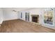 Open-concept living room with wood floors, stone fireplace, and sliding glass doors to a deck at 846 Brandy Oaks Ln, Stone Mountain, GA 30088