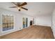 Large living room featuring wood floors, a stone fireplace, and access to a wooden deck with tree views at 846 Brandy Oaks Ln, Stone Mountain, GA 30088