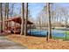 Well-maintained tennis court with a shaded pavilion and surrounding trees at 846 Brandy Oaks Ln, Stone Mountain, GA 30088