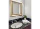 Bathroom vanity with dark granite countertop and decorative gold-trimmed mirror at 325 E Paces Ferry Ne Rd # 410, Atlanta, GA 30305