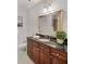 Bathroom featuring granite counters, dark wood cabinets, and a decorative mirror at 325 E Paces Ferry Ne Rd # 410, Atlanta, GA 30305