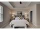 Bright bedroom featuring a tray ceiling, carpet, and a cozy king-sized bed at 325 E Paces Ferry Ne Rd # 410, Atlanta, GA 30305