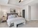 Bright bedroom featuring a tray ceiling, carpet, and a cozy king-sized bed at 325 E Paces Ferry Ne Rd # 410, Atlanta, GA 30305