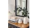 Stylish decor atop a wooden dresser, enhancing the room's ambiance with greenery and textures at 325 E Paces Ferry Ne Rd # 410, Atlanta, GA 30305