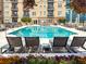 Outdoor community pool with lounge chairs, flowers, and views of the building at 325 E Paces Ferry Ne Rd # 410, Atlanta, GA 30305