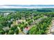 Aerial view showcasing the proximity to Ivy Creek Greenway and Suwanee Town Center in a neighborhood surrounded by lush trees at 3980 Suwanee Place Dr, Suwanee, GA 30024