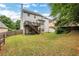 Expansive backyard with patio, lawn, and mature trees at 3980 Suwanee Place Dr, Suwanee, GA 30024