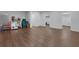 Spacious finished basement featuring wood floors, ample lighting, and access to different areas at 3980 Suwanee Place Dr, Suwanee, GA 30024