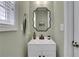 Bathroom featuring a modern sink with black hardware, and a decorative mirror at 3980 Suwanee Place Dr, Suwanee, GA 30024