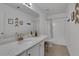 Well-lit bathroom featuring a marble countertop, a single sink and a combined shower tub at 3980 Suwanee Place Dr, Suwanee, GA 30024