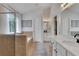 Bright bathroom showcasing double sinks with marble countertops, a soaking tub and a glass-enclosed shower at 3980 Suwanee Place Dr, Suwanee, GA 30024