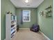 Charming room with cozy chair, shelving, and ample natural light at 3980 Suwanee Place Dr, Suwanee, GA 30024