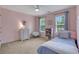 Comfortable pink bedroom with two windows, a dresser, and a blue bed at 3980 Suwanee Place Dr, Suwanee, GA 30024