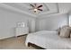 Bedroom with tray ceiling, large dresser, carpet, and neutral colors at 3980 Suwanee Place Dr, Suwanee, GA 30024
