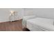 Clean bedroom featuring hardwood floors, bright lighting, and a closet at 3980 Suwanee Place Dr, Suwanee, GA 30024