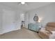 Neutral bedroom with a fan, a dresser with a mirror and a chair at 3980 Suwanee Place Dr, Suwanee, GA 30024