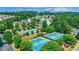 Aerial view of the community pool and tennis courts, surrounded by lush greenery and well-maintained landscaping at 3980 Suwanee Place Dr, Suwanee, GA 30024
