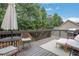 Relaxing deck with comfortable seating and umbrella for shade at 3980 Suwanee Place Dr, Suwanee, GA 30024