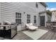 Outdoor deck with grill, seating, and wood flooring at 3980 Suwanee Place Dr, Suwanee, GA 30024