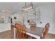 Dining area features hardwood floors, modern light fixture and open access to the modern kitchen at 3980 Suwanee Place Dr, Suwanee, GA 30024