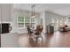Bright dining area showcases a modern light fixture and lots of natural light with backyard views at 3980 Suwanee Place Dr, Suwanee, GA 30024