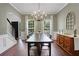 Bright dining room featuring a dark wood table, modern chandelier, and neutral wall color at 3980 Suwanee Place Dr, Suwanee, GA 30024