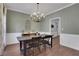 Inviting dining room with modern lighting and a large table, perfect for Gathering gatherings at 3980 Suwanee Place Dr, Suwanee, GA 30024