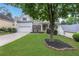 Inviting home featuring lush lawn, mature trees, and a two-car garage at 3980 Suwanee Place Dr, Suwanee, GA 30024
